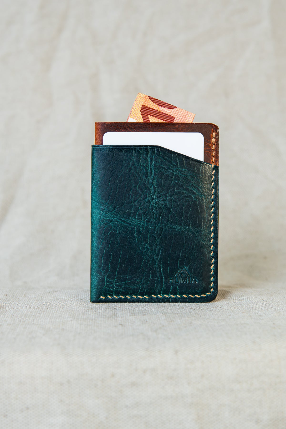 Porte-cartes Bastan en cuir turquoise et cognac, vue de face avec carte et billet