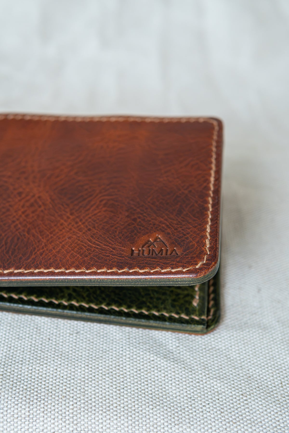 Portefeuille Vignemale en cuir cognac et olive, détails sur le logo